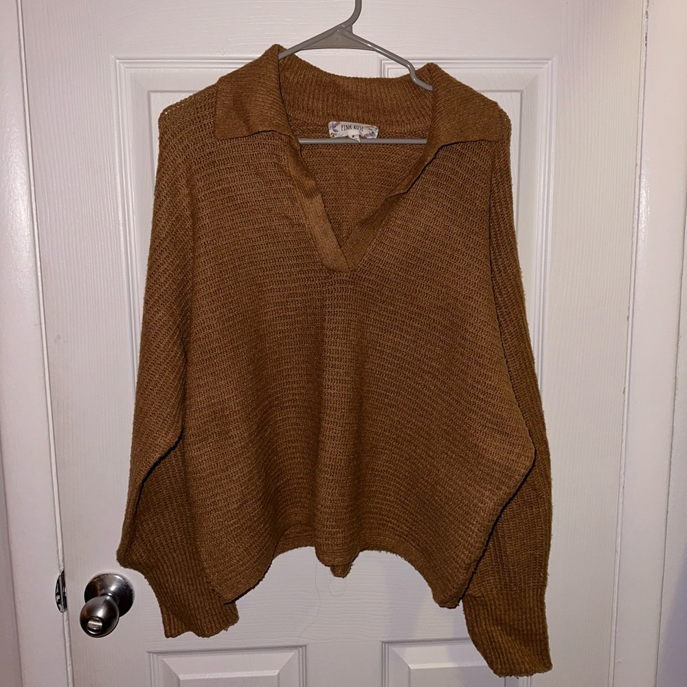 Burnt orange sweater with collar. Size medium.